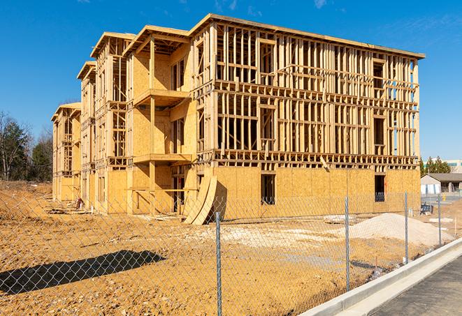 a close-up of temporary chain link fences enclosing a job site, signaling progress in the project's development in Fargo ND